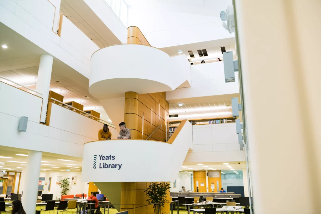 Students talking on the stairs of the Yeats Library on the Sligo Campus.