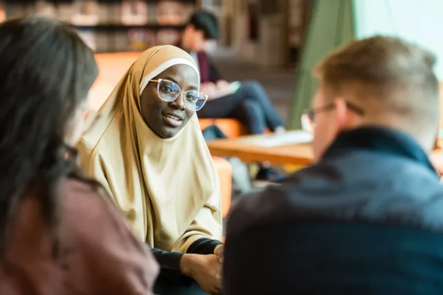 Students are sat together and talking