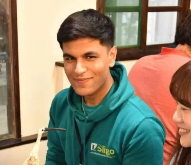 Male student in green hoodie