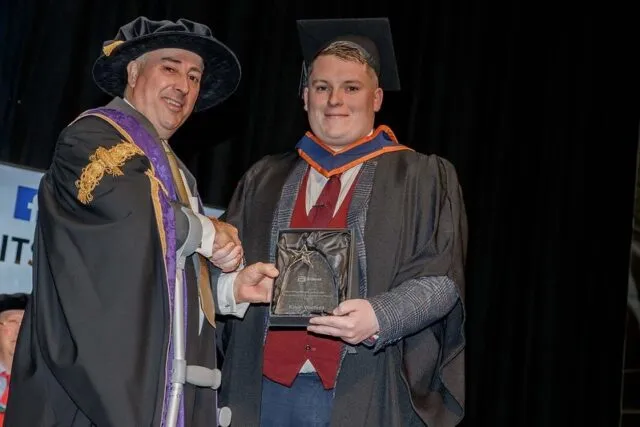Student being presented with award at graduation