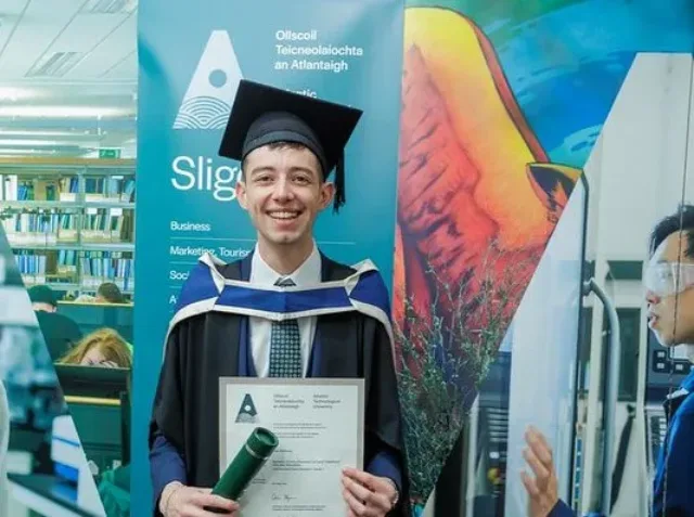 ATU Graduate Kyle holding degree