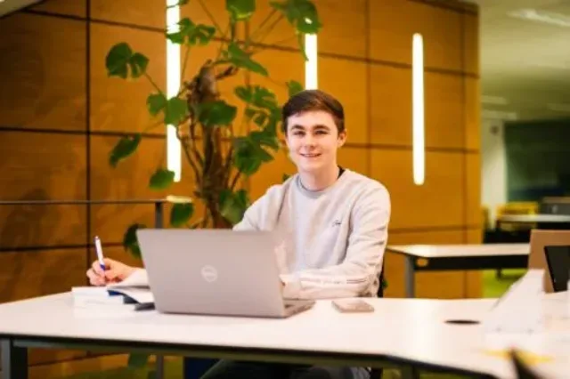 ATU student Luke sitting at Laptop