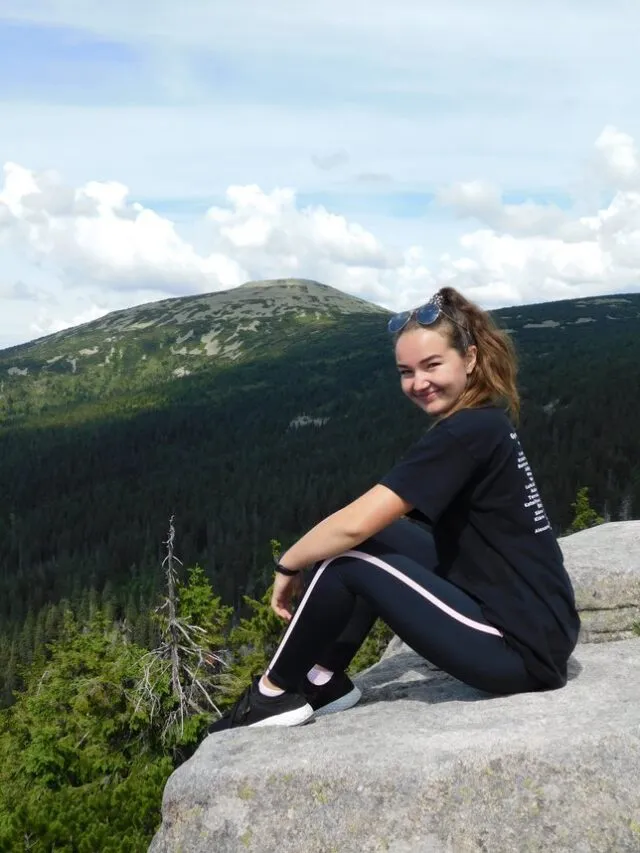 ATU Sarah sitting on cliff in the countryside