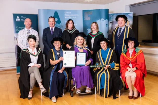 Alumni and graduate holding degree