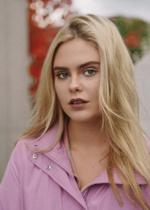 Female with blonde hair and pink shirt