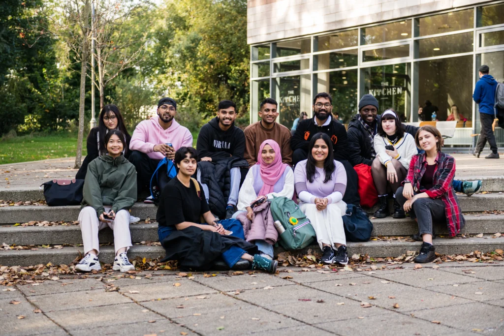 Group of international student sitting on steps together.