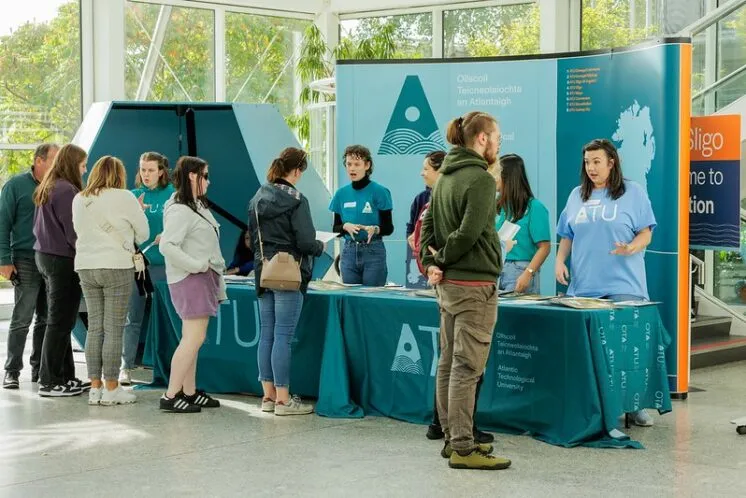 Student Ambassadors greeting new students at the helpdesk in the main foyer
