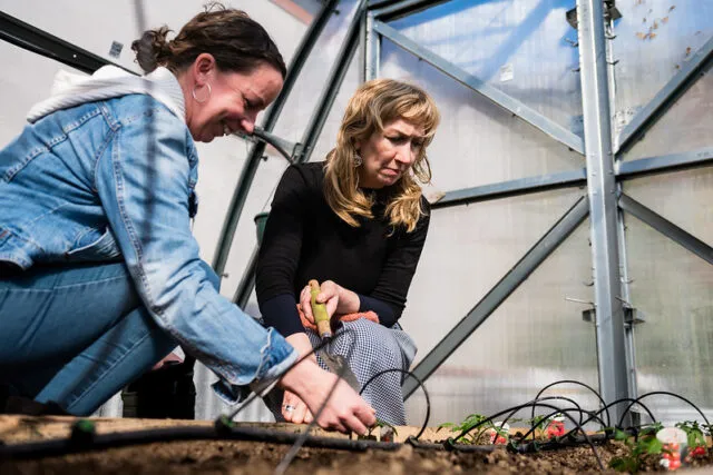 Two students examining soil.