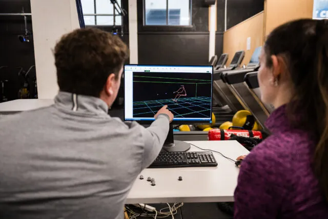 Lecturer demonstrates sports performance technology as part of digital innovation for sport course.