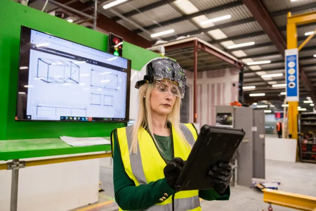 Girl reading from a tablet in a building environment
