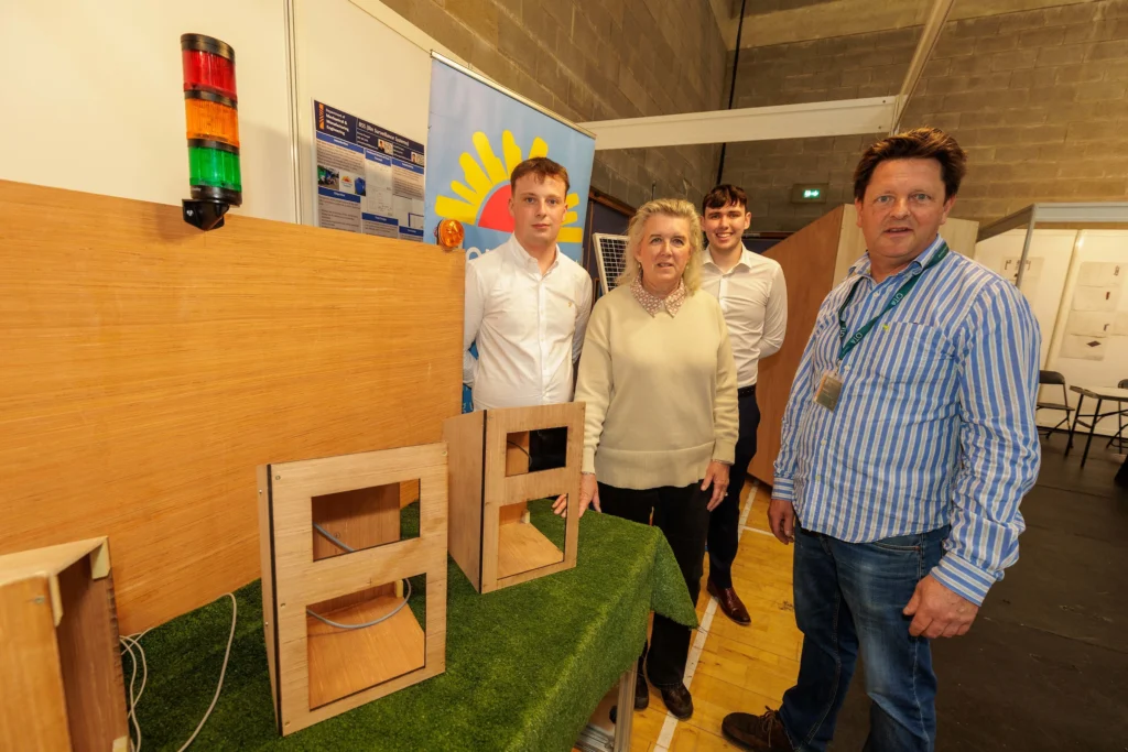 ATU Lecturer Robert Craig and Mary Forte from North West Hospice stand beside the "Bin Surveillance System," developed by ATU BEng students Joseph Flanaghan & Emmet Flanagan, who won the Mechanical and Precision Engineering (L7) Award, sponsored by Abbott.
