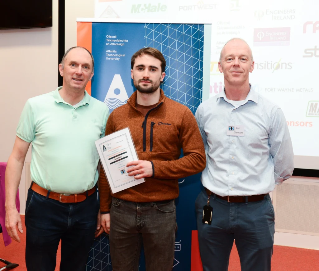 ATU representative, student, and award representative presenting a certificate to the student.