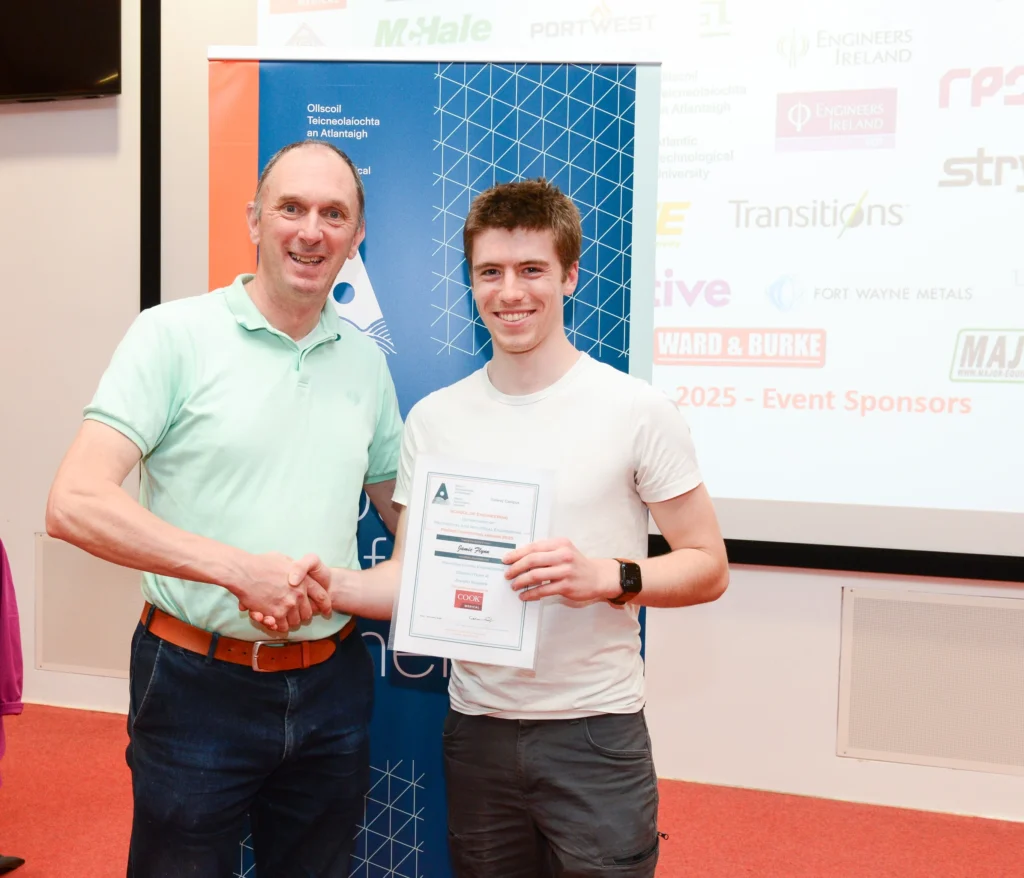 ATU representative presenting a certificate to the student