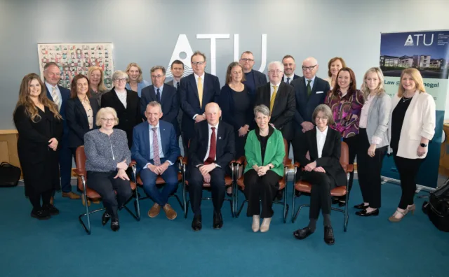 Group of picture including Supreme Court judges and ATU staff smile for a photo.