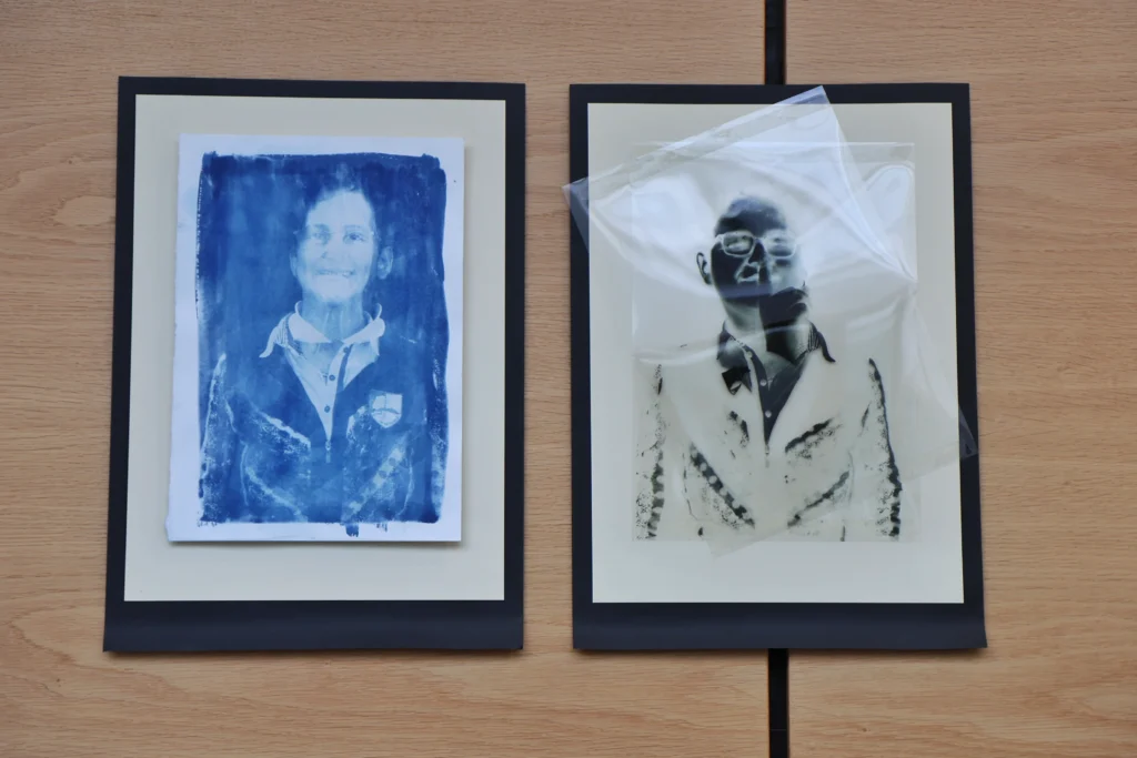 Two framed photos hang up in the Yeats Library part of the Creative Generations Portrait Photography Exhibition