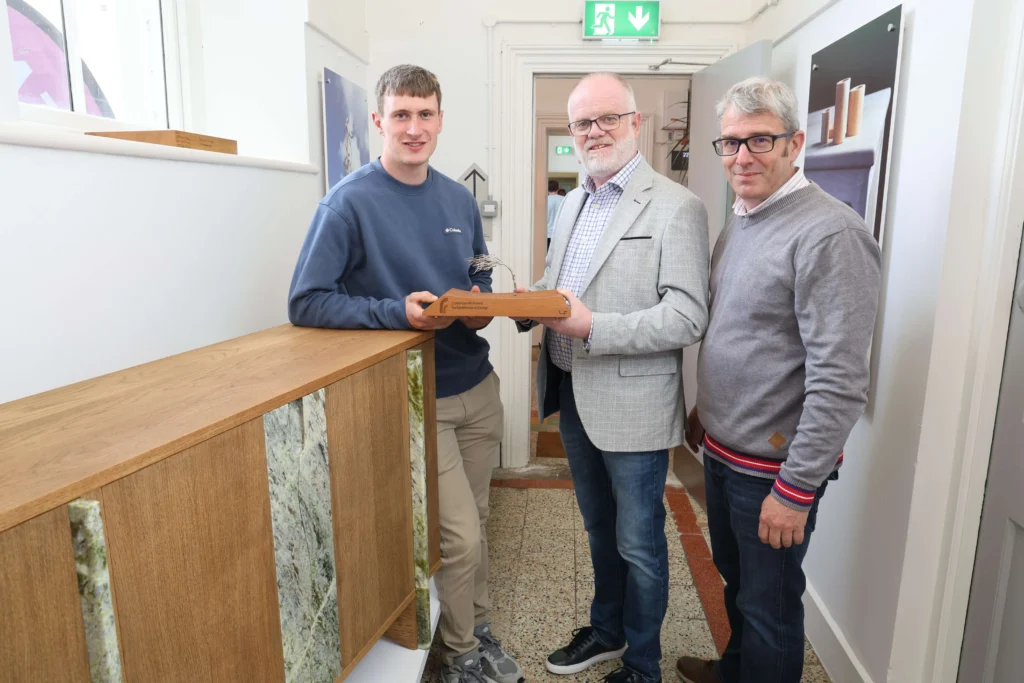 Student Liam O'Flaherty from Kilmoyley, Co Kerry who won the Conor Farrell Award for Excellent in Design, pictured with Paul Farrell from Farrell Furniture Ardee, and Jeremy Madden, ATU lecturer, pictured with his cabinet.