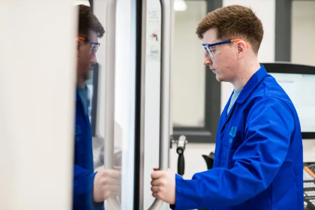 Researcher opening a door to special equipment