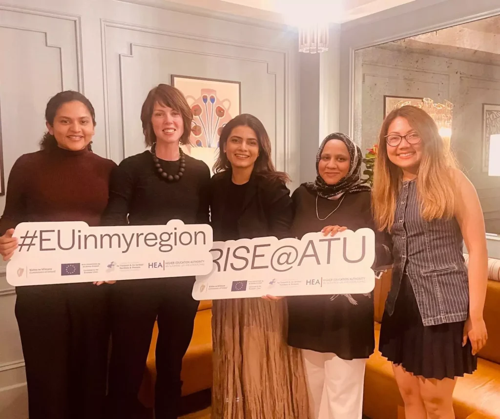5 people are standing smiling while holding signs that say "#EUinmyregion" and "Rise@ATU"