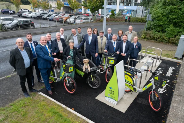 Electric bikes, including one with a dog inside it, are parked at the bike racks at the ROBUST eMobility Hub in Letterkenny. Local leaders come together to celebrate the launch of this new initiative promoting sustainable transport.