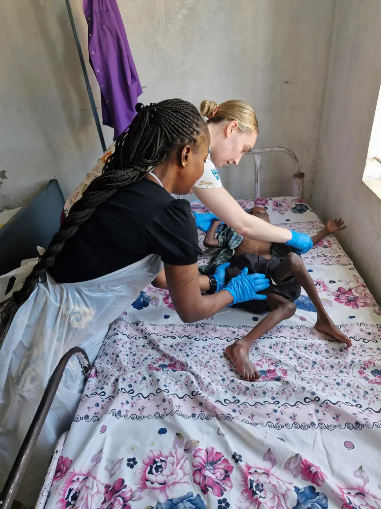 Student nurses assess a child at Noah's Ark School.