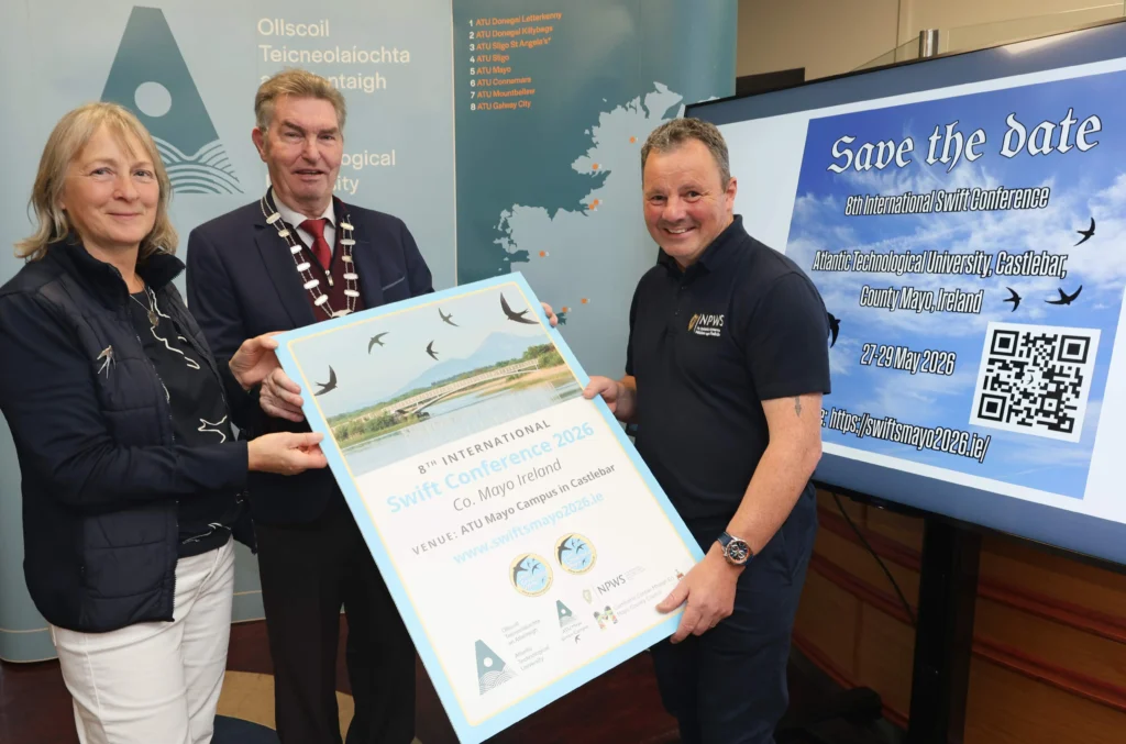 ATU member and two stakeholders hold large poster.