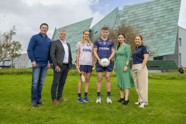 ATU and Kirby staff with two ATU student GAA players wearing new sponsored jerseys