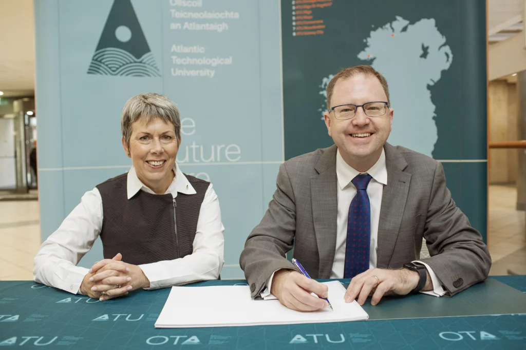 Minster James Lawless TD singing the visitor's book at ATU Letterkenny