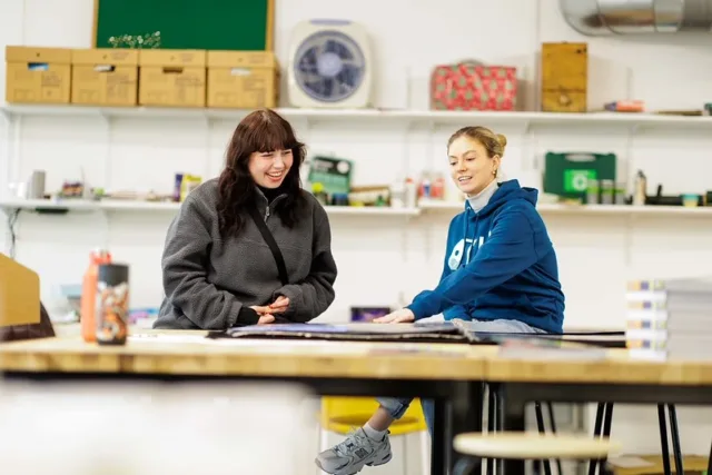 image of two people viewing a portfolio on an ATU campus
