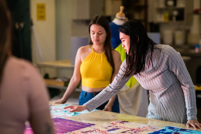 image of atu student and lecturer looking at textiles