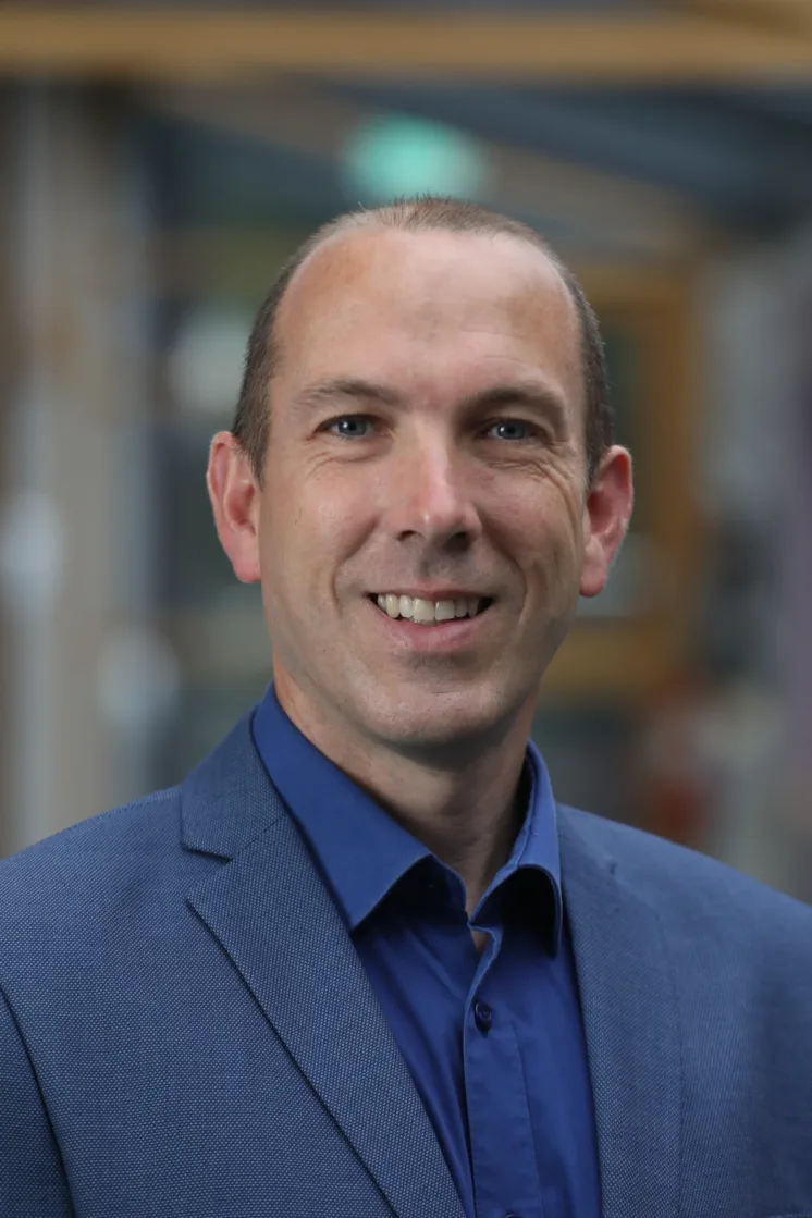 Headshot of Dr Kieran Ryan (ATU, KTI) wearing blue shirt and navy suit jacket.