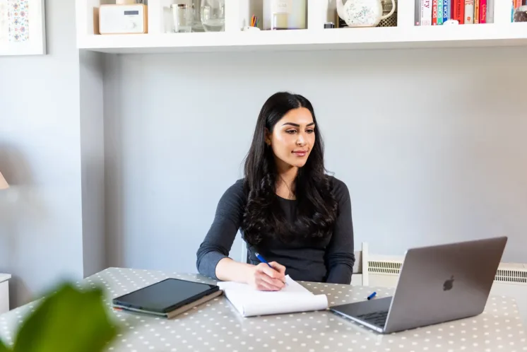 Woman at desk partaking in online learning
