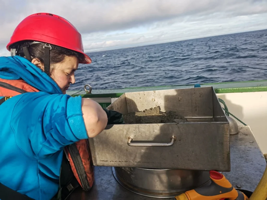 Researchers collect a seabed sample to study how carbon is stored in sediments.