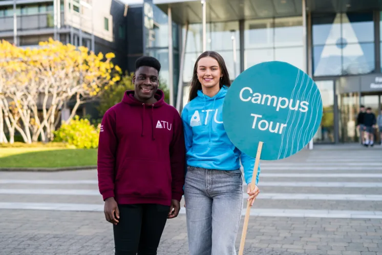 To volunteers at ATU Open Day holding Campus Tour signs