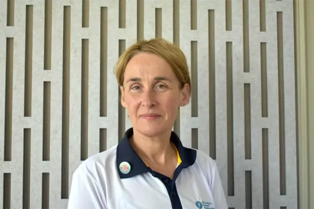 Female Postgraduate Student in a white top with navy collar