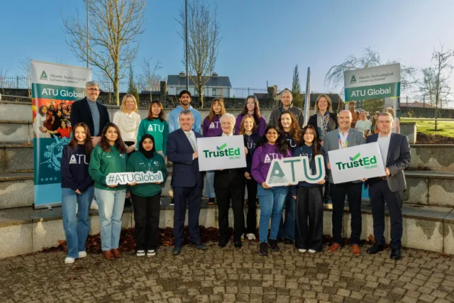Dr Billy Bennett, Registrar and Chief Academic Officer and John Andy Bonar, VP ATU Global with ATU Global staff and students receiving the TrustEd Ireland international quality mark supporting ATU's global ambition and international demand.
