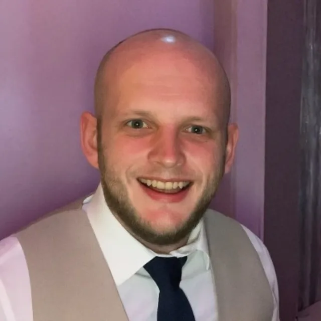 Male in a tie smiling