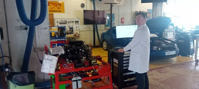 Profile photo for Enda Cosgrave, working at a monitor in a mechanics workshop.