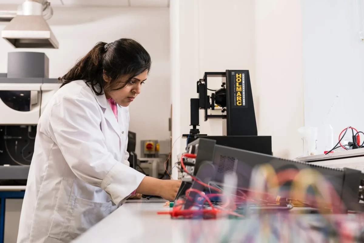 researcher adjusting sensors with wires