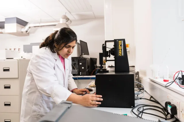 researcher adjusting equipment