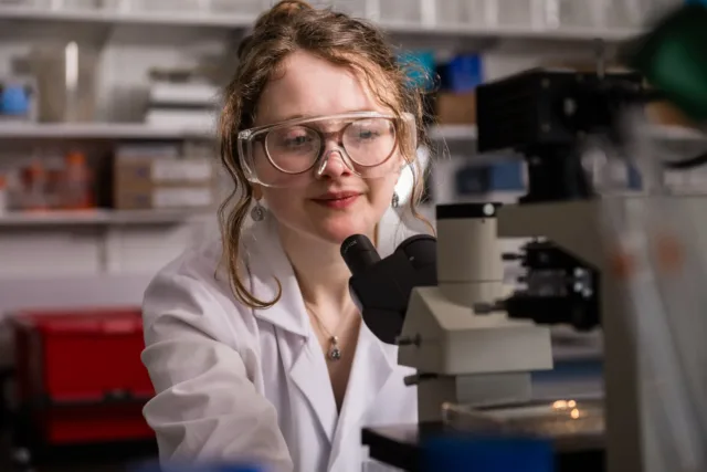 Student looking at microscope