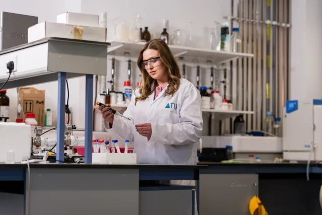 Researcher looking at lab equipment
