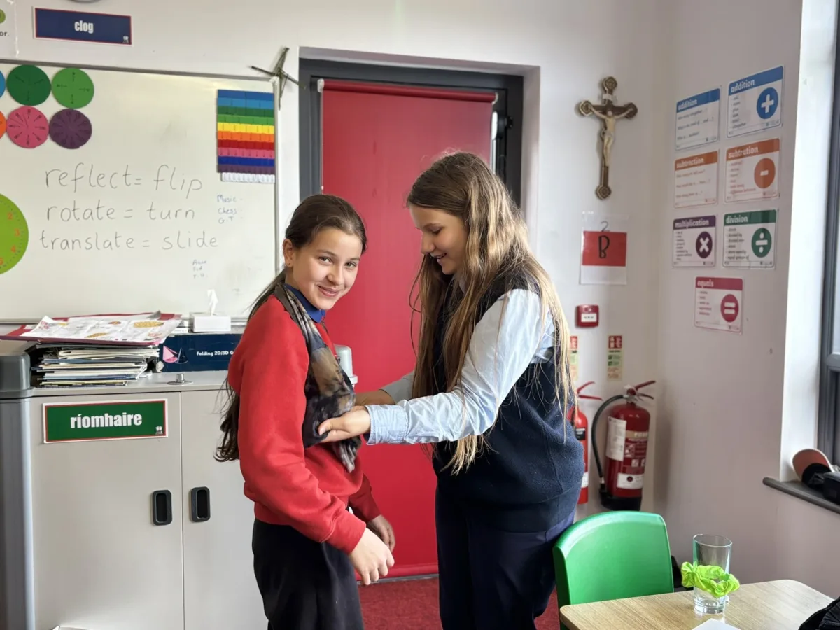Two students trying on clothes