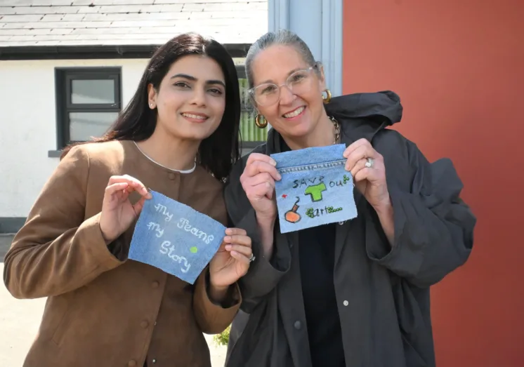 Sheila and Madiha holding samples of painted jean pockets