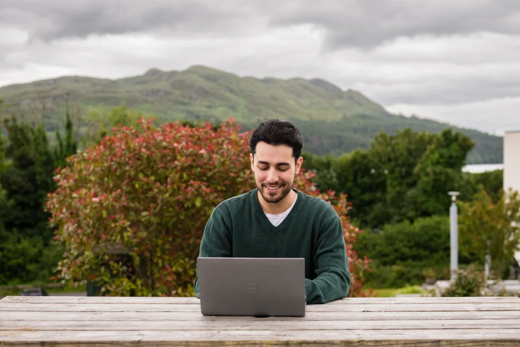 Male student studying outdoors at St Angelas campus