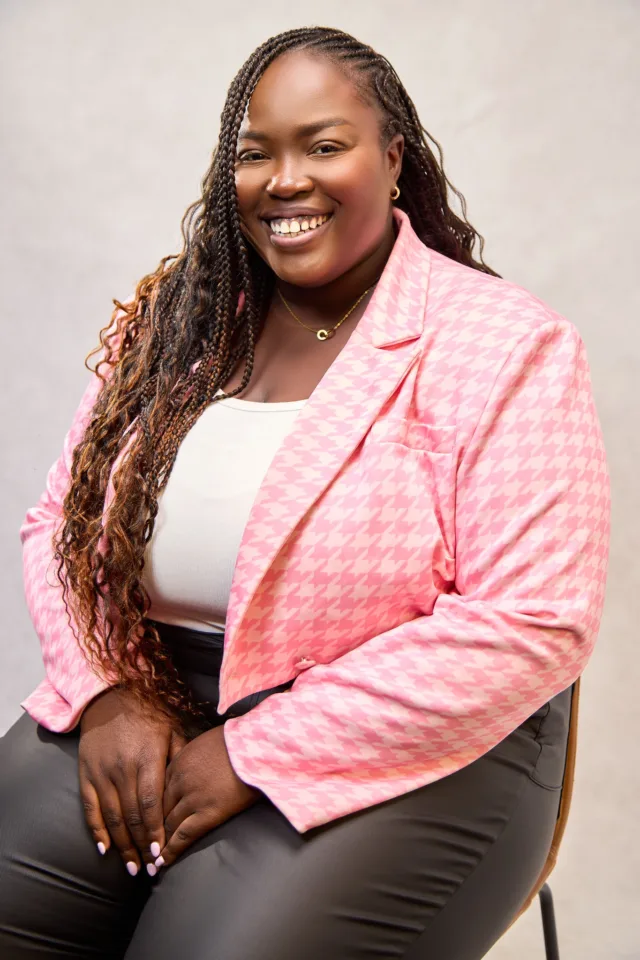 headshot of a smiling female student with pink blazer