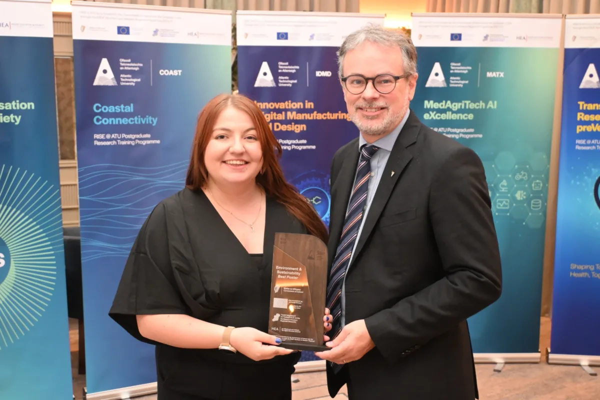 Female student Morena Gaudino receiving award from CEO of Research, Innovation, and Engagement.