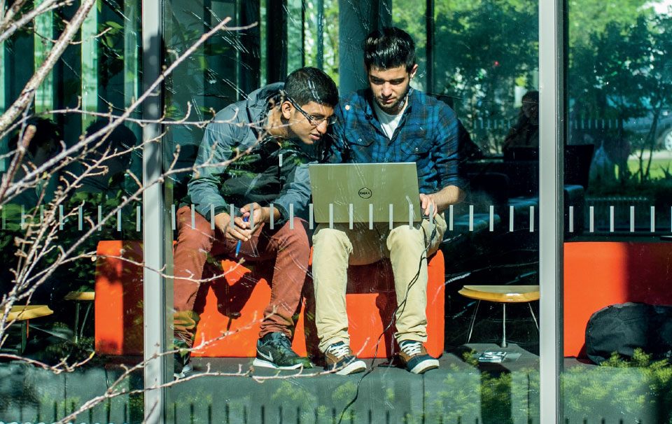 Two international students sitting in window of ATU Sligo library