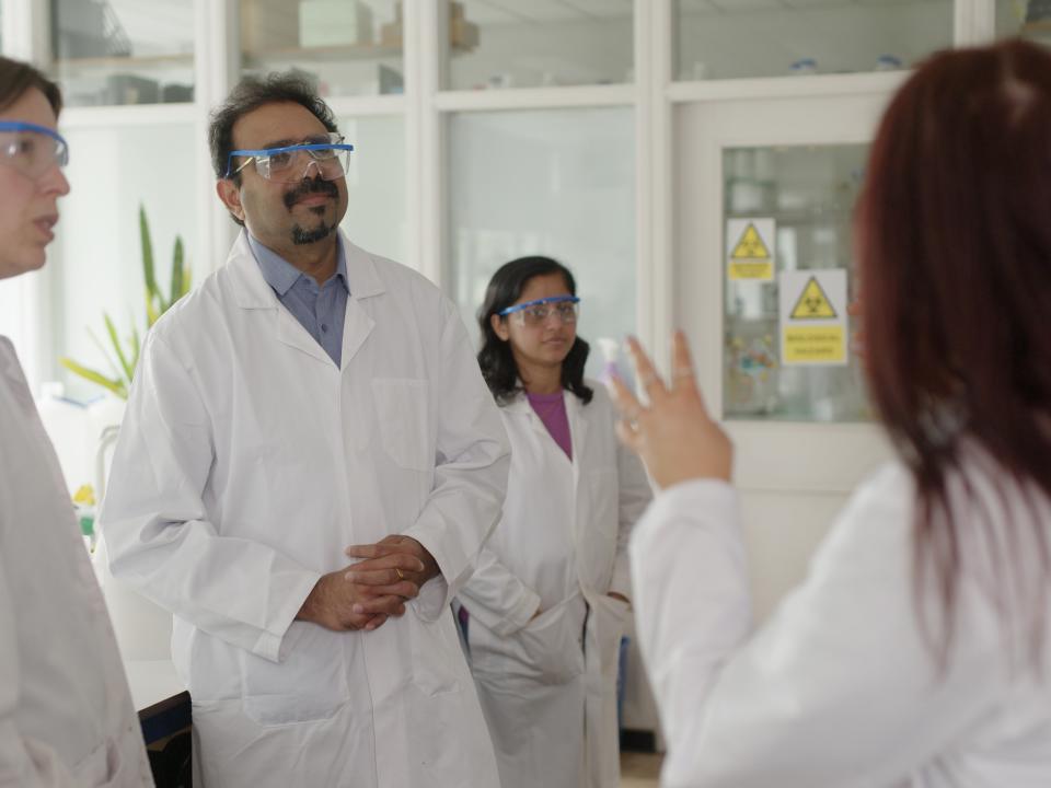prof-paula-colavita-and-dr-suresh-pillai-with-a-group-of-researchers-in-a-lab.jpg